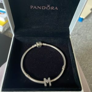 Silver pandora bracelet with “M” charm